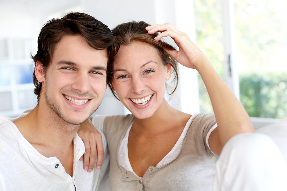 Smiling, tranquil happy couple at home