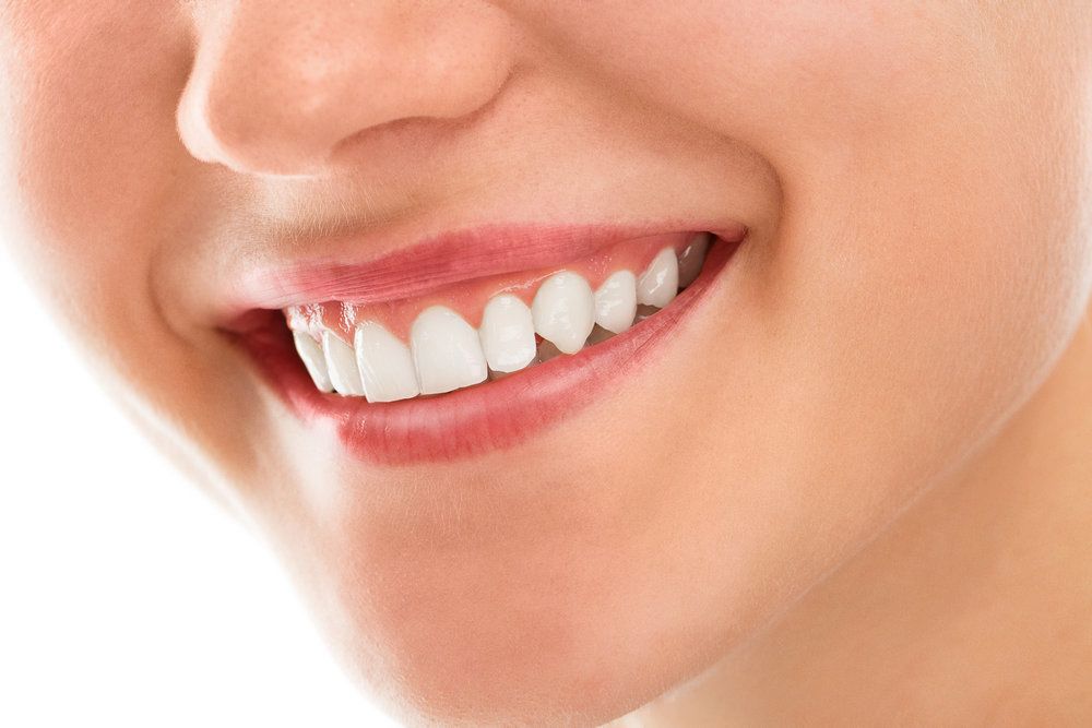 Upclose shot of woman’s mouth with healthy pink gums.