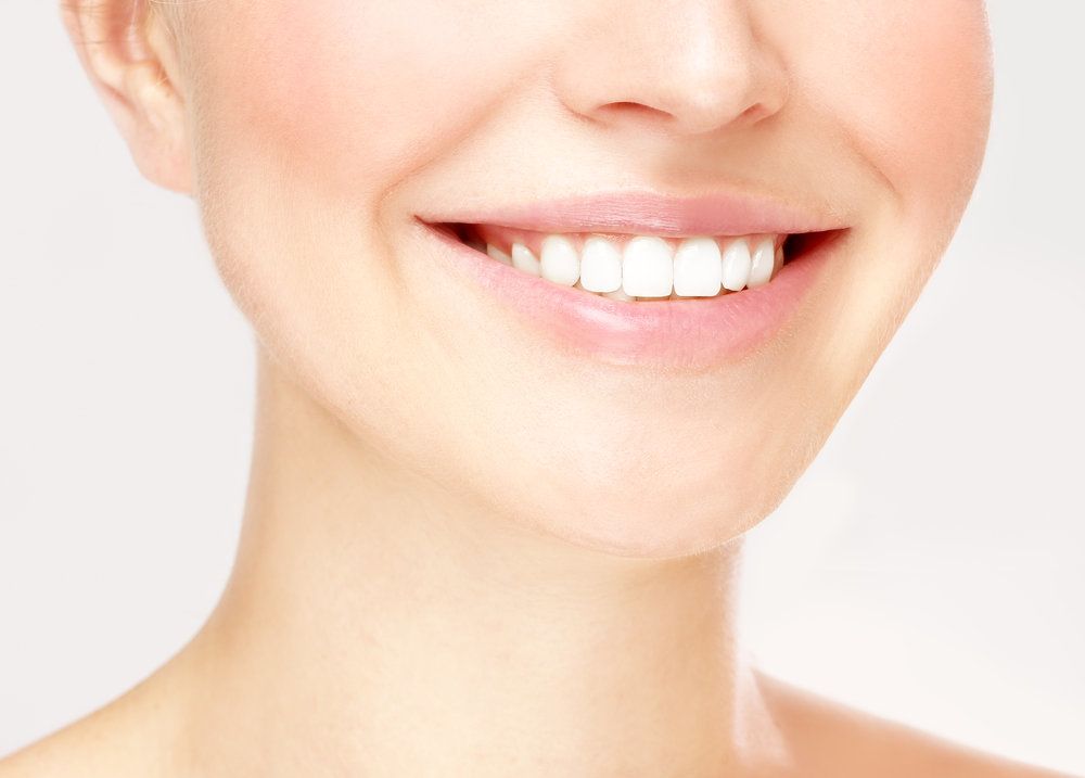 Close-up of woman’s mouth with healthy teeth.