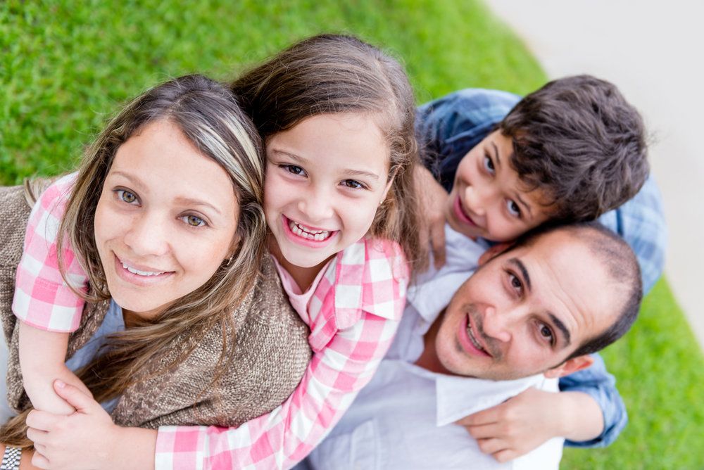 smiling family playing outdoors